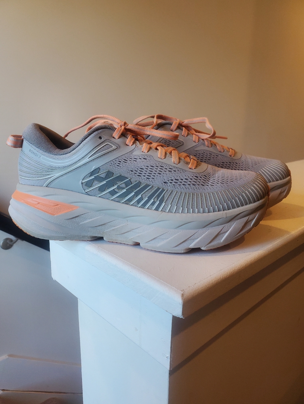 HOKA Bondi 7 running shoes in a clean gray & peach colorway